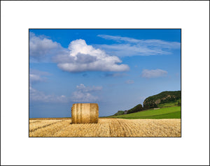 A lone hay bale in the field near Ballintoy Harbour by John Taggart Landscapes.