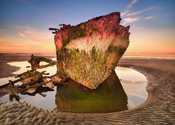 Baltray shipwreck at sunrise on Donegal coast with reflections in tidal pool Ireland landscape photograph
