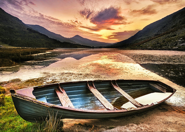 A photographic print of a lone boat in the Black Valley in County Kerry Ireland at sunrise