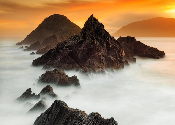 Blasket Islands Kerry Ireland seascape sunset with jagged rocks and misty long exposure Atlantic ocean