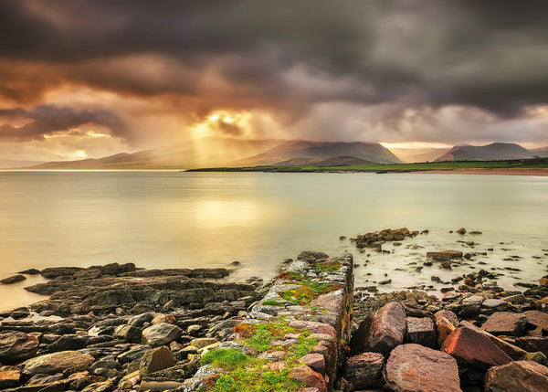 Brandon Bay County Kerry Ireland with dramatic sky and sun rays over mountains, rocky shoreline and calm sea landscape photography