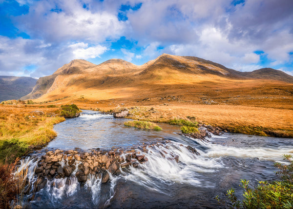 The beautiful Bundoragha River with its lovely waterfalls winds its way through the mountains at the edge of the Delphi Valley in Connemara Ireland by John Taggart Landscapes