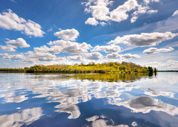 Carr Island on Lough Erne in County Fermanagh with sky reflections on calm water