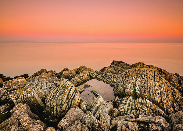 Clogherhead County Louth sunset rock pool with orange sky and rugged coastal rocks Ireland landscape photography