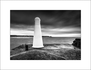 Cullen Harbour and Lighthouse on the Moray Firth Scotland which has guided many a fisherman home safely from the sea. Scottish landscape photography b John Taggart