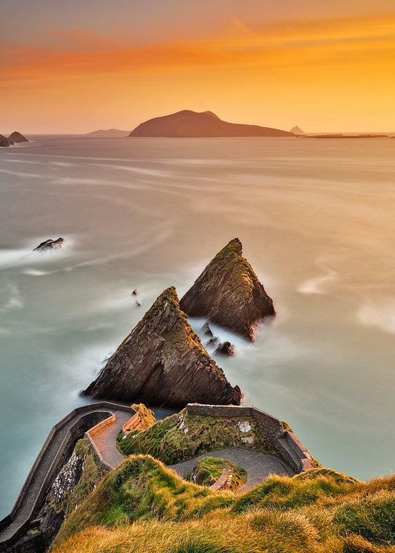 Dunquin Pier at sunset, Dingle Peninsula County Kerry Ireland with golden sky and Blasket Islands, long exposure coastal landscape photography