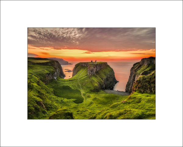 Summer sunset at Dunseverick Castle Ruins on the Causeway Coast, a majestic place on the Atlantic Ocean and at certain times of the year the sunsets are spectacular. By Irish landscape photographer John Taggart