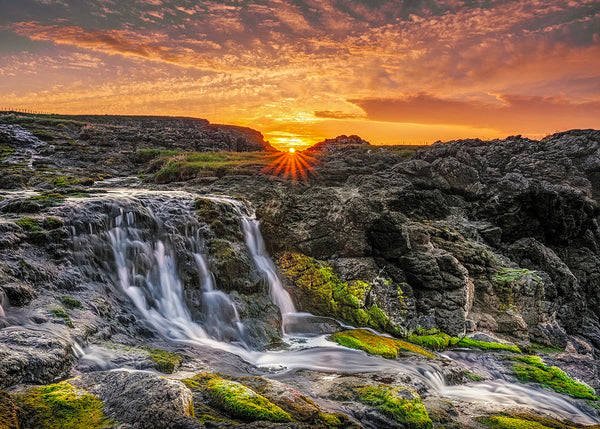 Dunseverick waterfall sunset County Antrim Irish coastal landscape long exposure moss rocks golden sky