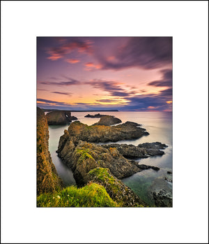 Evening Light at beautiful Ballintoy on the Causeway Coast as the sun sets behind the rocks by Fine Art Landscape Photographer John Taggart