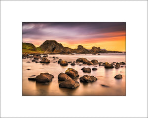 Evening light at beautiful Ballintoy on the scenic Causeway Coast as the sun sets behind the sea stacks by irish landscape photographer John Taggart