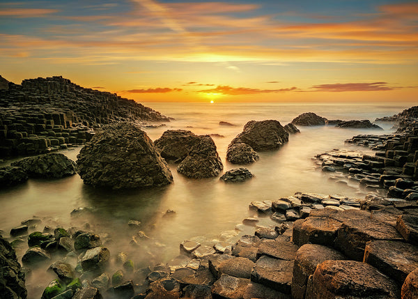 Giant’s Causeway sunset with basalt columns and calm sea County Antrim Northern Ireland landscape photography John Taggart