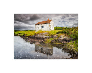 The Gillie's Hut reflected in Connemara County Galway by John Taggart Irish Landscape  Prints and beautiful wall art.