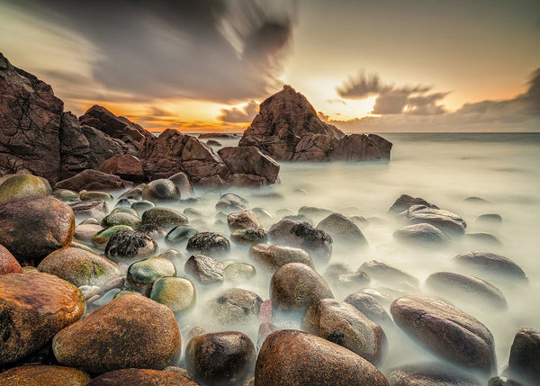 Gweedore rocks at sunset Donegal Ireland long exposure coastal landscape with smooth water and dramatic sky