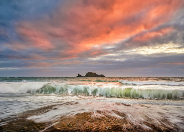 Kilfarrasy Beach County Waterford with rolling Atlantic wave and colourful sunset sky