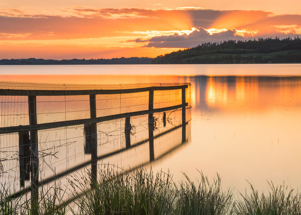 Bring the quiet magic of Irish Wall Art into your space with this fine art landscape photograph, featuring a beautiful sunset surrounded by rich golden light by Irish Photographic Artist John Taggart