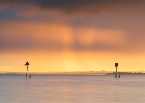 Golden sunset over navigation markers on Lough Neagh at Toomebridge, Northern Ireland.