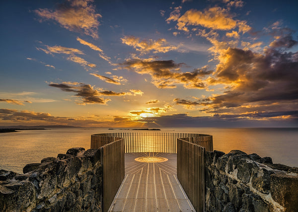 Magheracross viewpoint sunset over the Causeway Coast Northern Ireland with viewing platform and golden sky above the Atlantic Ocean