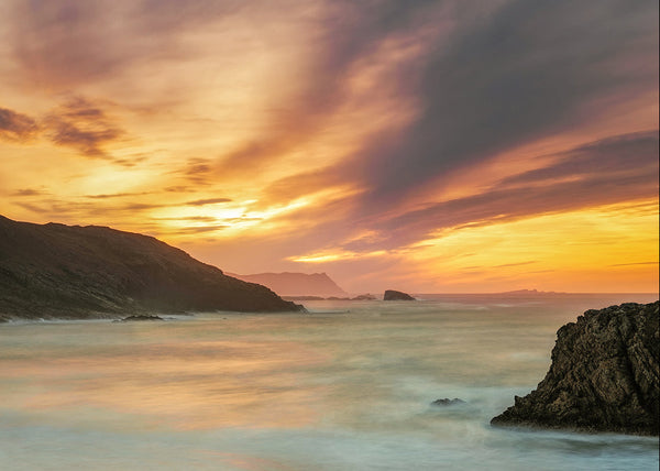 Melmore Head sunset Donegal Ireland coastal landscape with golden sky, sea stacks and soft ocean waves long exposure photography