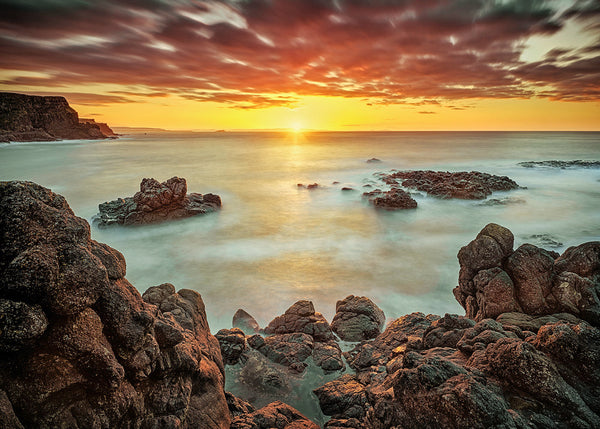 Giant’s Causeway sunset Northern Ireland long exposure seascape glowing sky rocks and smooth ocean water
