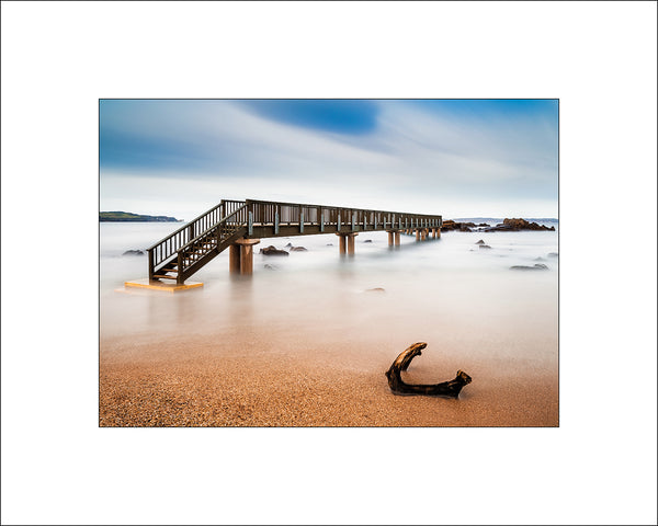 A Wooden Bridge stretching into the ocean at Pans Rock Ballycastle County Antrim were the legend of Dedire Of The Sorrows unfolds, a sad story of love romance and treachery. John Taggart Landscapes