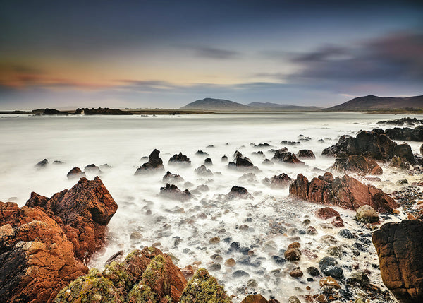 Tullagh Strand Donegal rocky coastline with misty long exposure waves and distant mountains along the Wild Atlantic Way