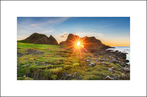 Sunset through the sea arch at Ballintoy County Antrim by John Taggart Landscapes