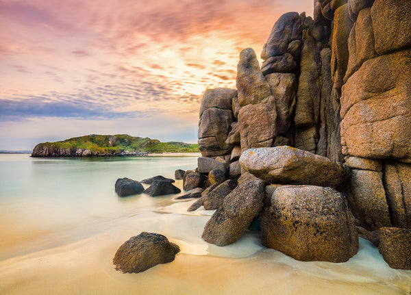 Golden light caresses the weathered granite cliffs at Carnboy on Boat Strand in County Donegal
The sun sets over the tranquil bay. The soft sands and still waters reflect the warm hues of the sky, capturing the serene beauty and timeless power of Ireland's Wild Atlantic Way
