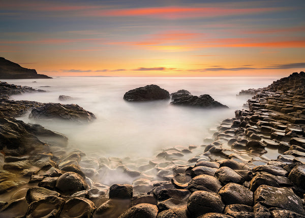 Evening light across the stones at the famous Giants Causeway in County Antrim by Irish Landscape Photographic Artist John taggart