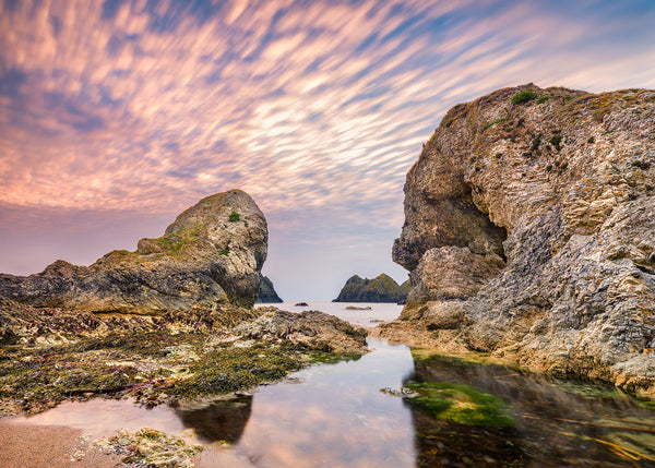 A breathtaking view of Ballintoy’s rugged coastline in County Antrim Ireland bathed in the soft glow of evening light.