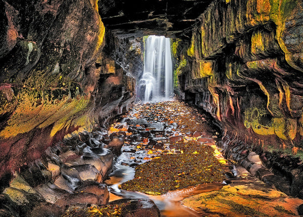 hidden waterfall cave Donegal mossy rocks flowing water autumn tones landscape photography