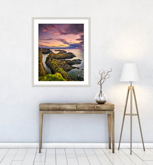 Evening Light at beautiful Ballintoy on the Causeway Coast as the sun sets behind the rocks by Fine Art Landscape Photographer John Taggart