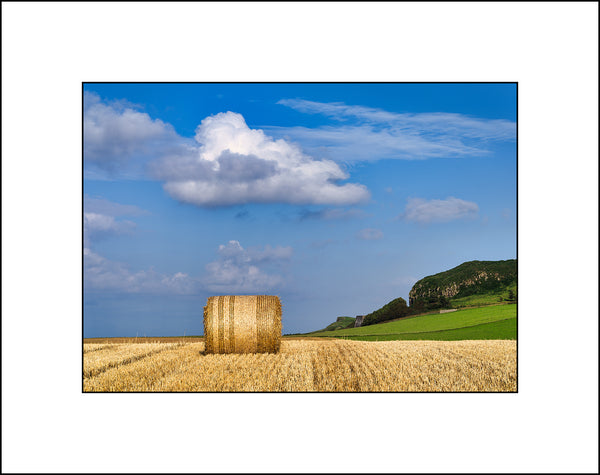 A lone hay bale in the field near Ballintoy Harbour by John Taggart Landscapes.