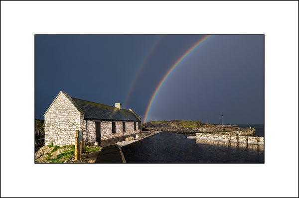 Stormy skies and beautiful rainbows over Ballintoy harbour by John Taggart Landscapes