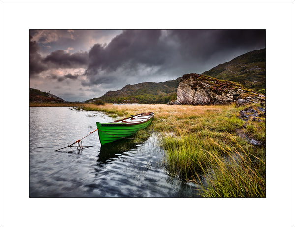 Upper lake Killarney in Co kerry were a little boat rests among the grasses by Irish Landscape Photographer John Taggart